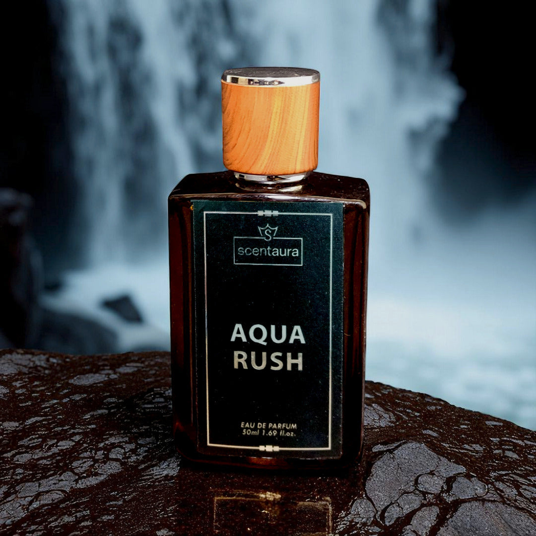 Perfume bottle labeled 'Aqua Rush' by 'scentaura' with a wooden cap on a dark surface.