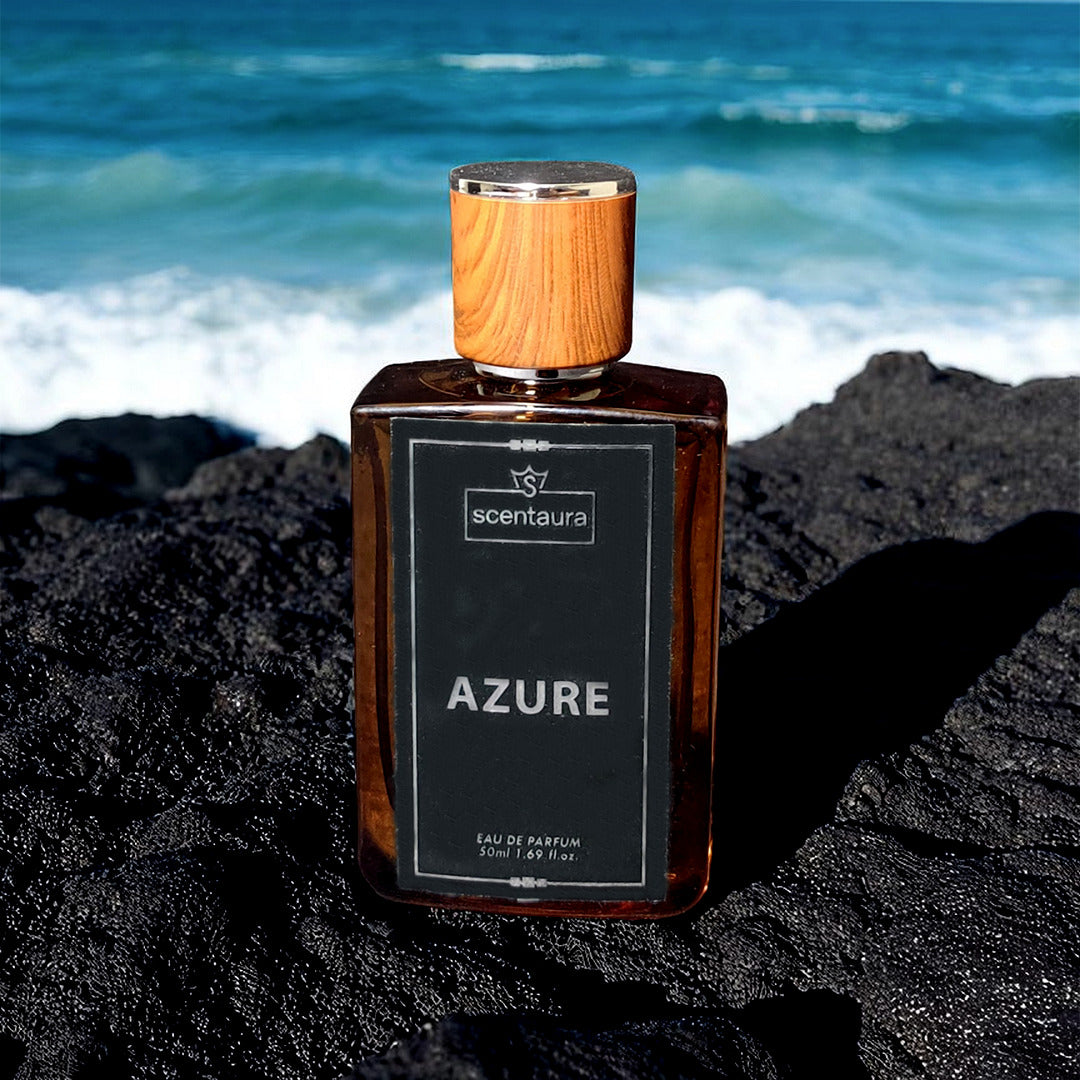 Scentura Azure perfume bottle on black sand with ocean in the background